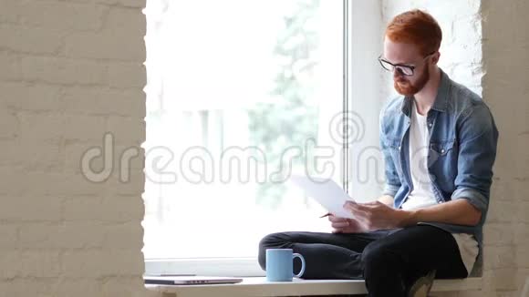 阅读文件文书放松的人坐在窗口胡子视频的预览图