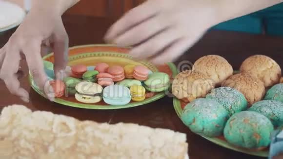 女人的糕点厨师手把五颜六色的杏仁摆在桌上视频的预览图