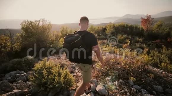日落时分一个人背着背包来到一座山上视频的预览图