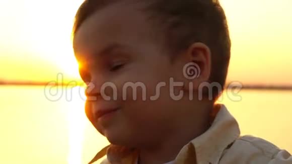 在夕阳的映衬下小孩在镜头中摇着头视频的预览图