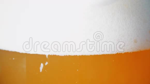 白色泡沫滑下啤酒玻璃超高清视频视频的预览图