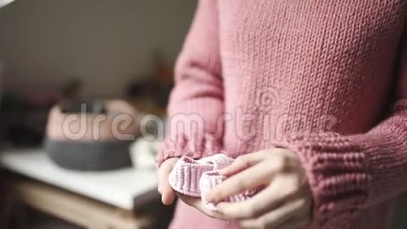 女性手拿着婴儿鞋儿童手工编织鞋视频的预览图