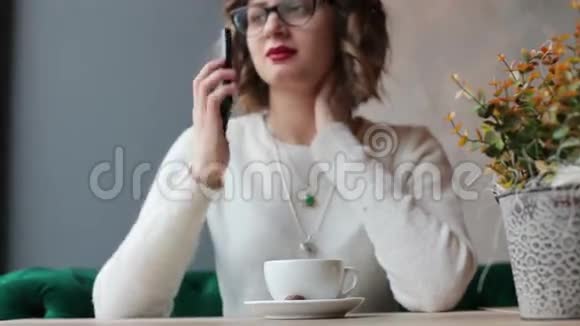 女人一边聊天一边坐在桌旁喝咖啡视频的预览图