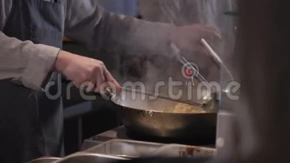 厨师是炒面与蔬菜和肉在炒锅视频的预览图