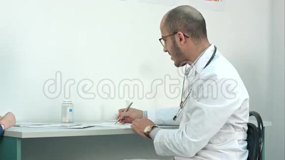 微笑的医生检查后给小病人一个棒棒糖视频的预览图