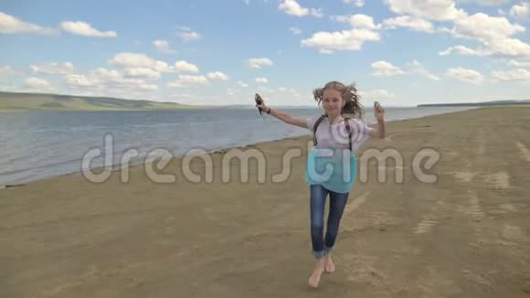 少年在沙滩上蹦蹦跳跳听音乐视频的预览图