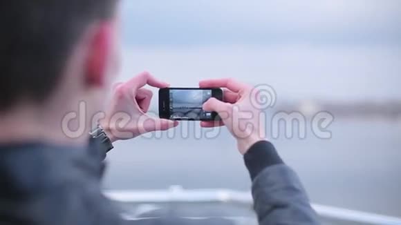 男人用智能手机拍摄城市的照片视频的预览图