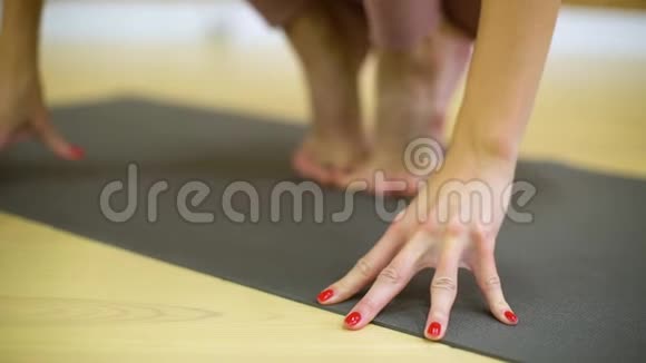 年轻女子在瑜伽课上慢动作练习瑜伽视频的预览图