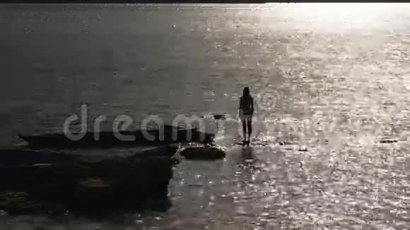 一个女人在水波荡漾的背景上的轮廓视频的预览图