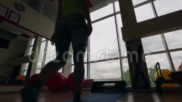年轻女孩在健身房表演体式深色框架视频的预览图