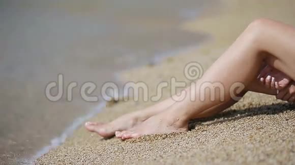 女人在白沙滩上美丽光滑的腿视频的预览图