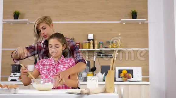 美丽的母亲和年轻的面手一起在厨房做饭视频的预览图