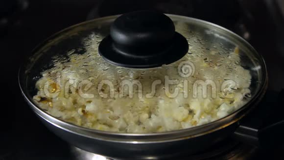 爆米花开始在煎锅里爆炸高清镜头视频的预览图