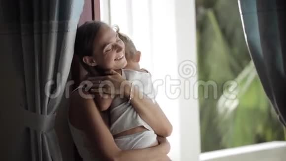 漂亮的母亲抚慰和拥抱哭泣的女婴视频的预览图
