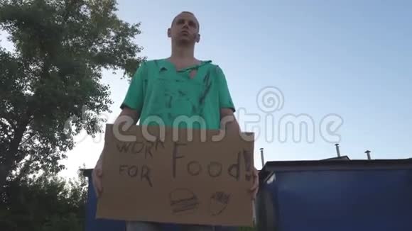 街上的流浪汉很累在纸板上签名用于食物视频的预览图