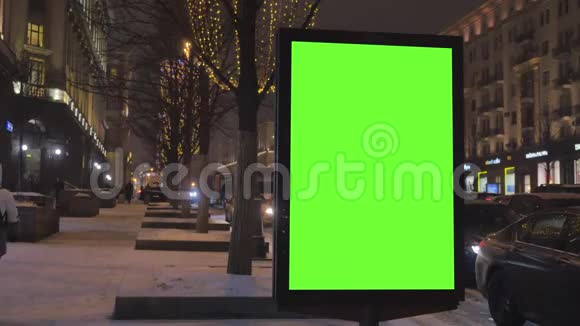 一个大广告牌街道上有一个绿色的屏幕为节日装饰视频的预览图