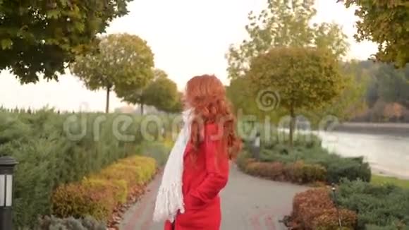秋天公园里美丽的女人凉爽的风日视频的预览图