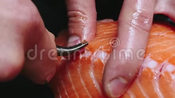 厨师从三文鱼片中取出骨头切鱼片上的鱼以4k分辨率慢动作烹饪寿司视频的预览图