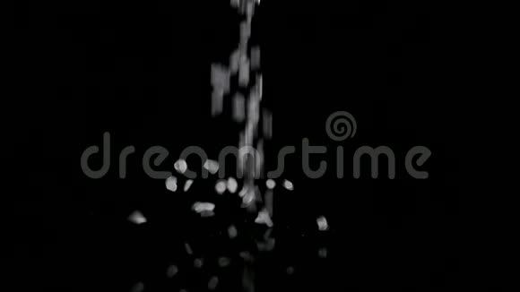 粗糙的海盐晶体落在黑色背景上视频的预览图