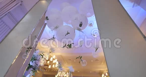 最初的婚礼花饰以小花瓶和花束的形式悬挂在天花板上视频的预览图