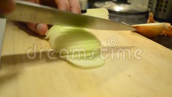 一只手拿刀在木板上砍洋葱视频的预览图