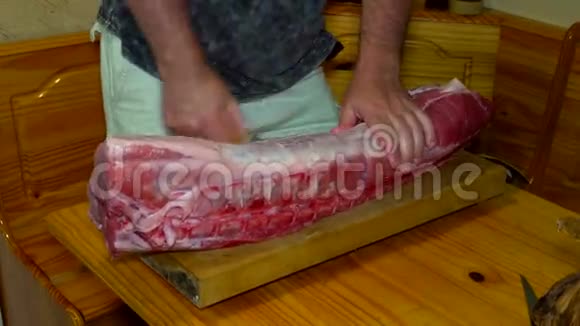 厨师切割生猪肉准备烹饪的木板视频的预览图