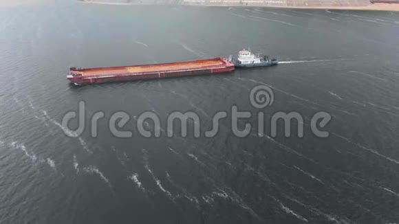 空中勘测俯视图一艘带有船沙的驳船漂浮在河上视频的预览图