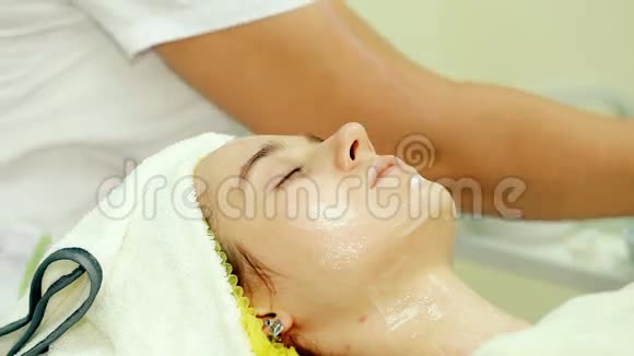 医生美容师在女人脸上涂了奶油视频的预览图