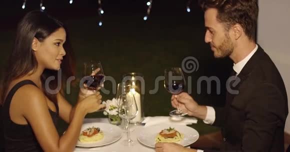 一对年轻夫妇在晚餐时啜饮红酒视频的预览图