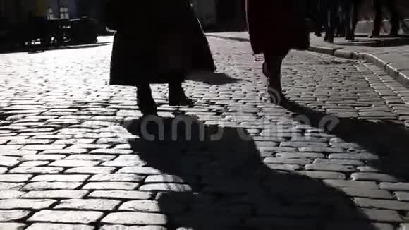 在人行道上发出刺耳的脚步声石头路面上的灯光视频的预览图