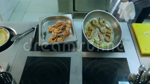 厨师在锅中煎虾时加入盐和大蒜视频的预览图