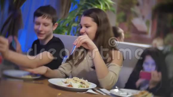 少女在快餐店吃沙拉一群朋友坐在咖啡馆里吃晚饭视频的预览图