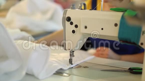 缝纫机和白色织物女手后缝纫女手缝纫制造服装厂女视频的预览图