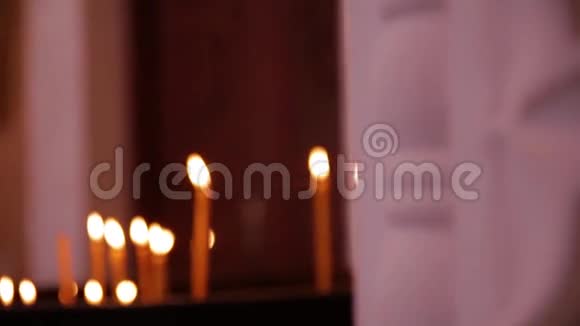 在东正教教堂里蜡烛在燃烧人们在教堂里点燃蜡烛图标视频的预览图