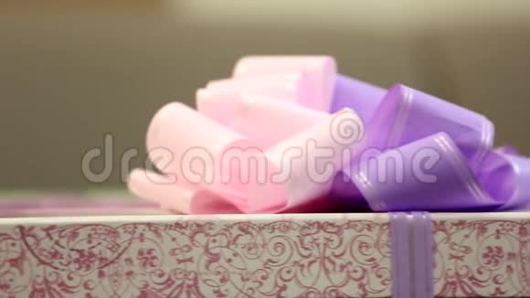 快乐可爱的小女孩孩子看起来拿着一个巨大的礼物盒包裹在紫色丝带蝴蝶结上视频的预览图