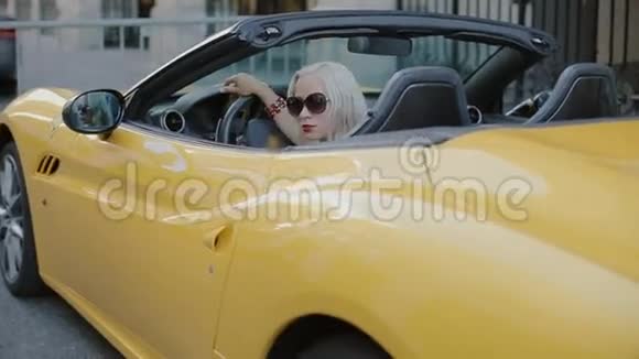 敞篷车车轮后面的金发女郎视频的预览图