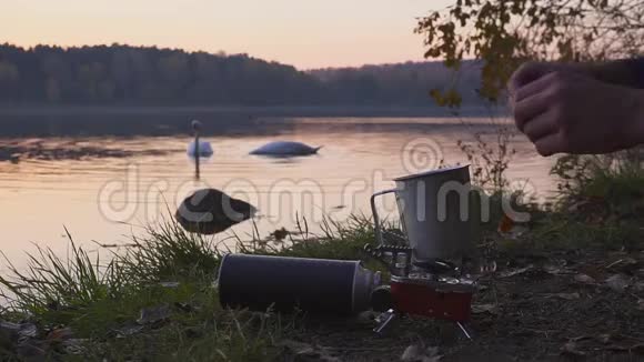 野营食品制作游客在煤气炉上煮咖啡茶或食物美丽的风景背景下的视频的预览图