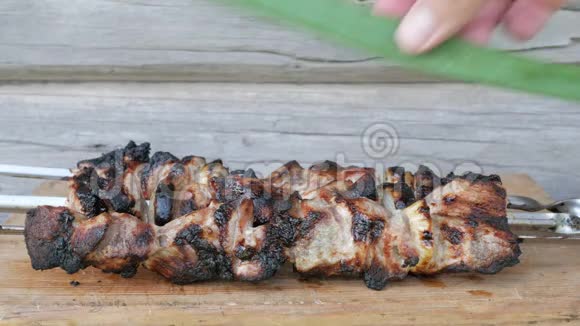 烤肉中的熟肉放在一块有洋葱的木板上粗糙轻微烧焦的碎片木制墙上视频的预览图