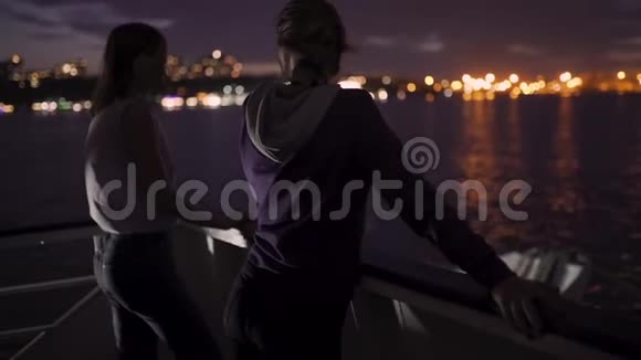 两个迷人的年轻女人在夜晚在船上旅行的剪影船上的女朋友视频的预览图