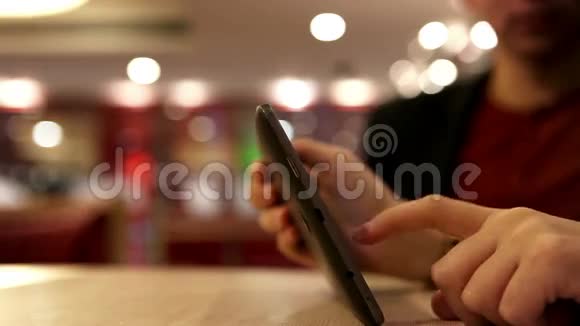 年轻女性指甲手指触摸平板电脑与夜店背景视频的预览图