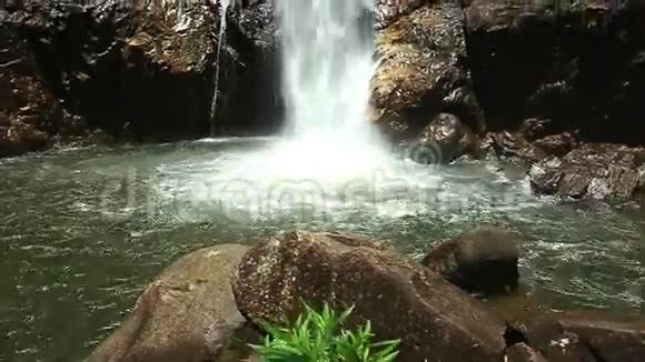 高高的瀑布跌入池塘泡沫在岩石间飞溅视频的预览图