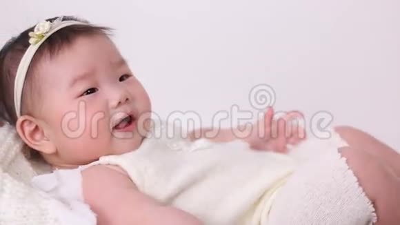 小亚洲女孩孩子是婴儿车婴儿床穿着白色西装视频的预览图
