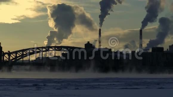 冬季城市景观桥过河流房屋烟囱和烟雾视频的预览图