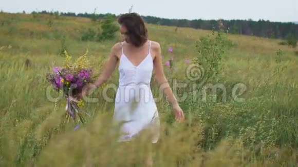 一位年轻女子在绿茵场上享受一束鲜花视频的预览图