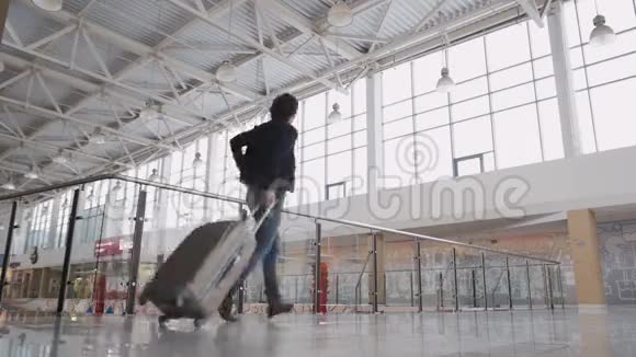 面目全非的人带着手提箱匆忙在机场候机楼或火车站带着行李的商人视频的预览图