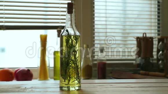 木桌上的橄榄油瓶特级初榨橄榄油和迷迭香香草本植物视频的预览图