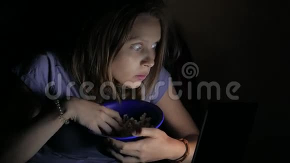 女孩在笔记本电脑上看恐怖电影4UHDK视频的预览图