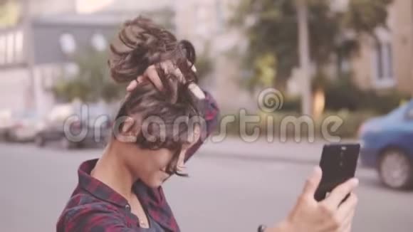 美丽的女孩在城市里散步时自拍视频的预览图