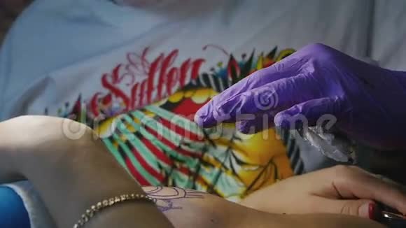 纹身师在女人的身体特写做纹身视频的预览图