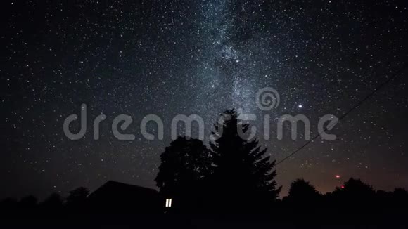 夏天的夜晚星星在树上的时间推移然后乌云在黑暗的天空出现视频的预览图